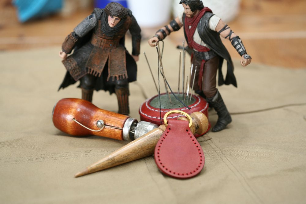 Handcrafted leather keyring with detailed stitching, available in brown and other colours